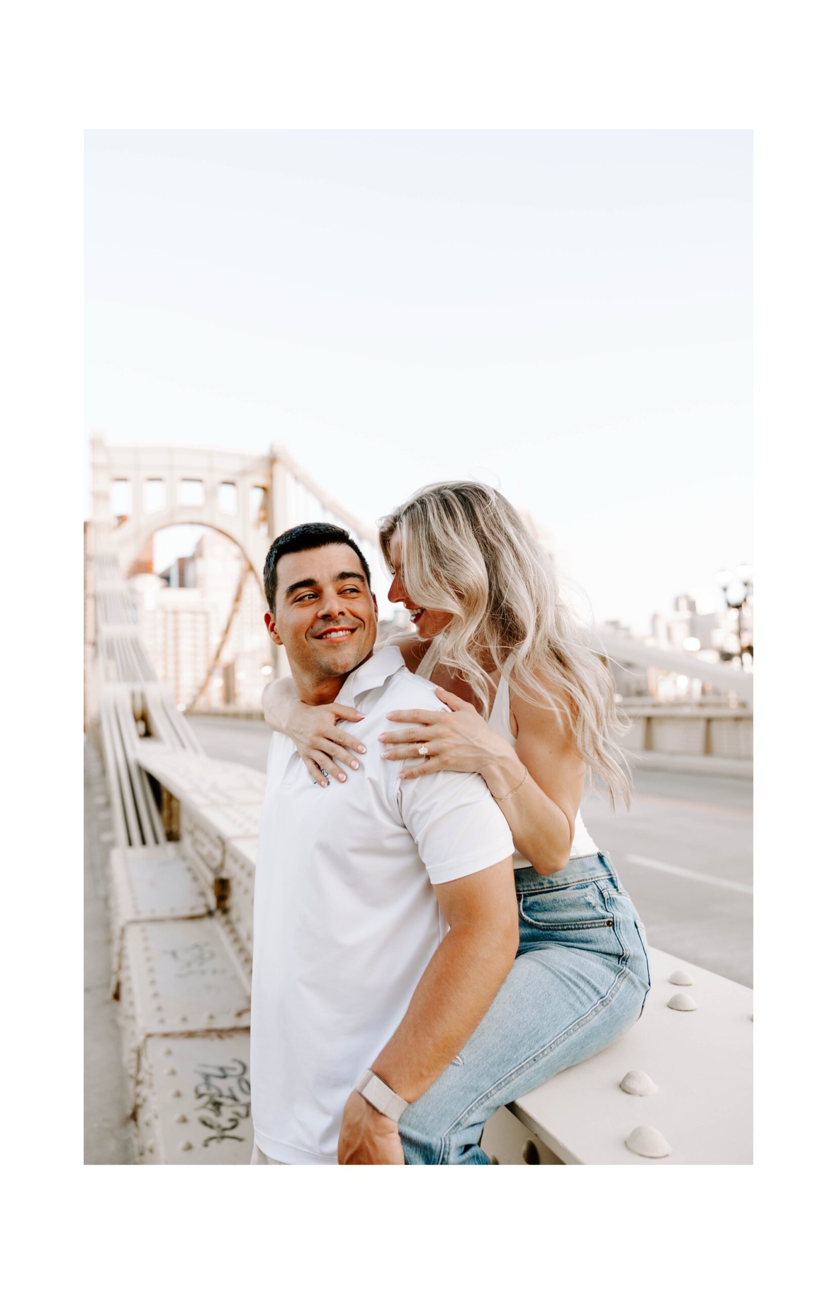 Casual engagement photos on Roberto Clemente Bridge at sunset