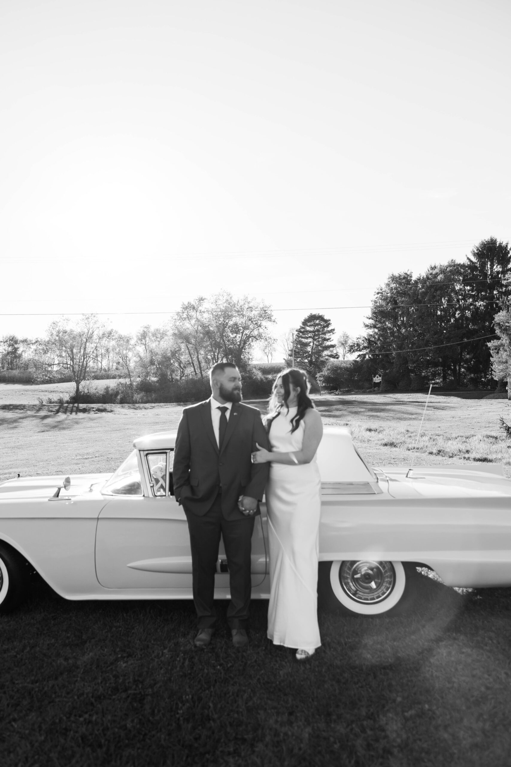 etro-inspired engagement photo with white satin dress and vintage car