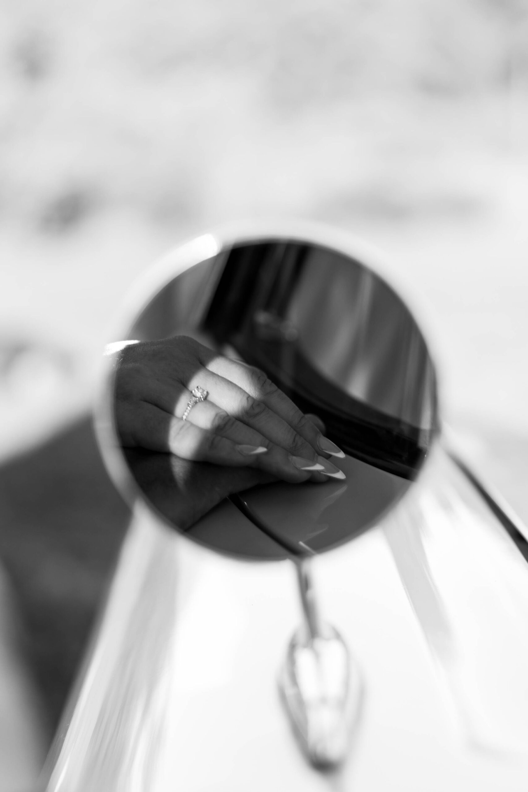 Creative save-the-date photo with couple posing beside vintage ca