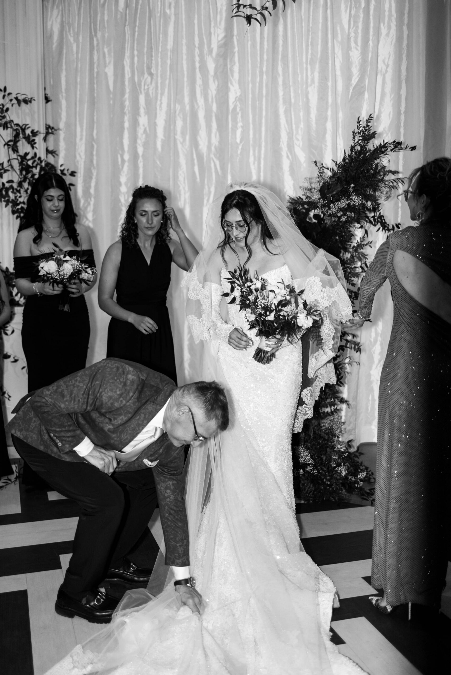 father fixing daughter's wedding gown train