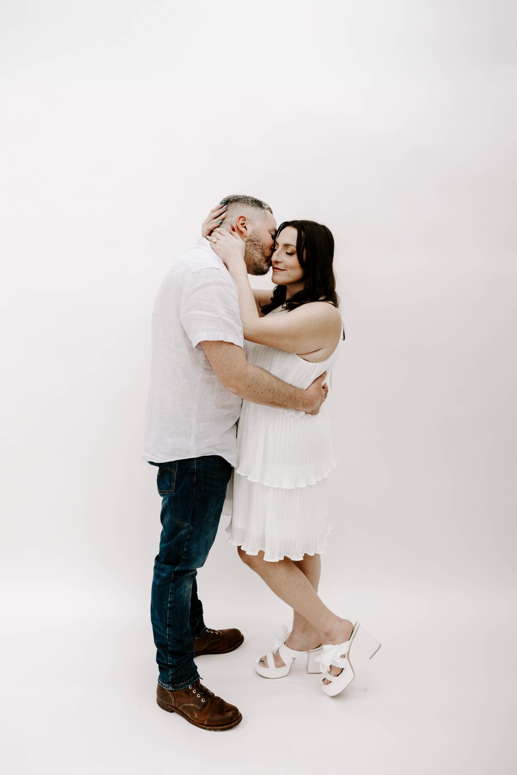 minimalist engagement photos in the studio, white backdrop studio sessions