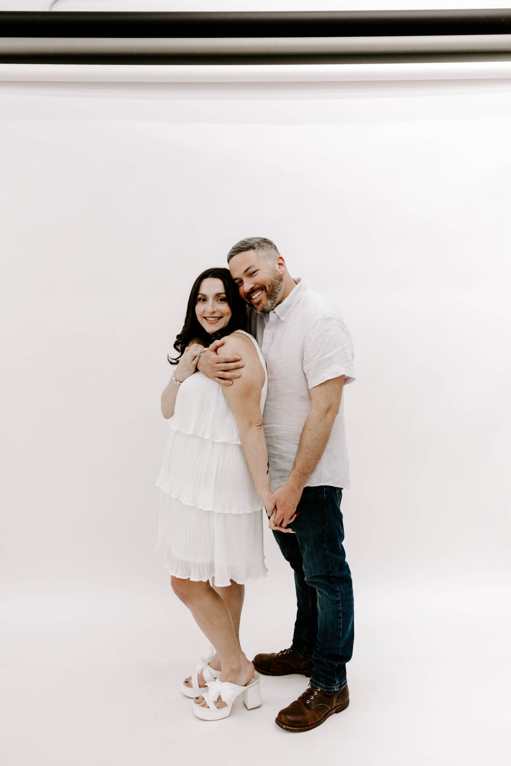 minimalist engagement photos in the studio, white backdrop studio sessions
