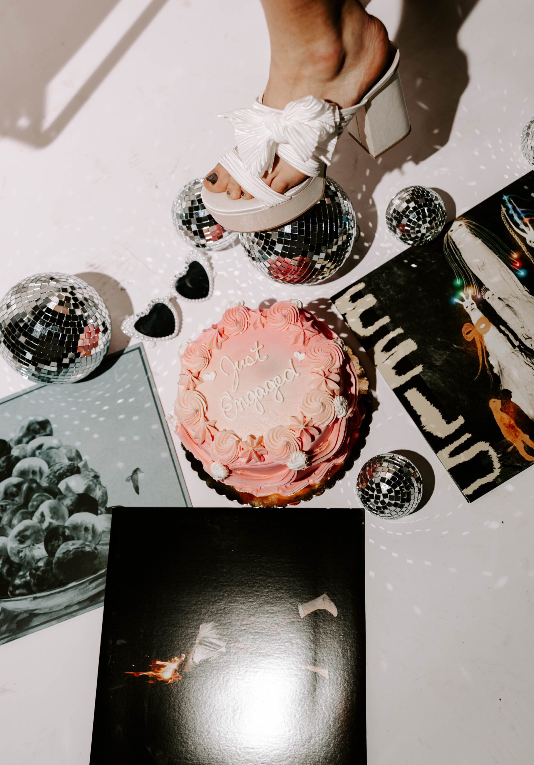 vinyl records, disco balls, and vintage-style cake for "just engaged" photo session