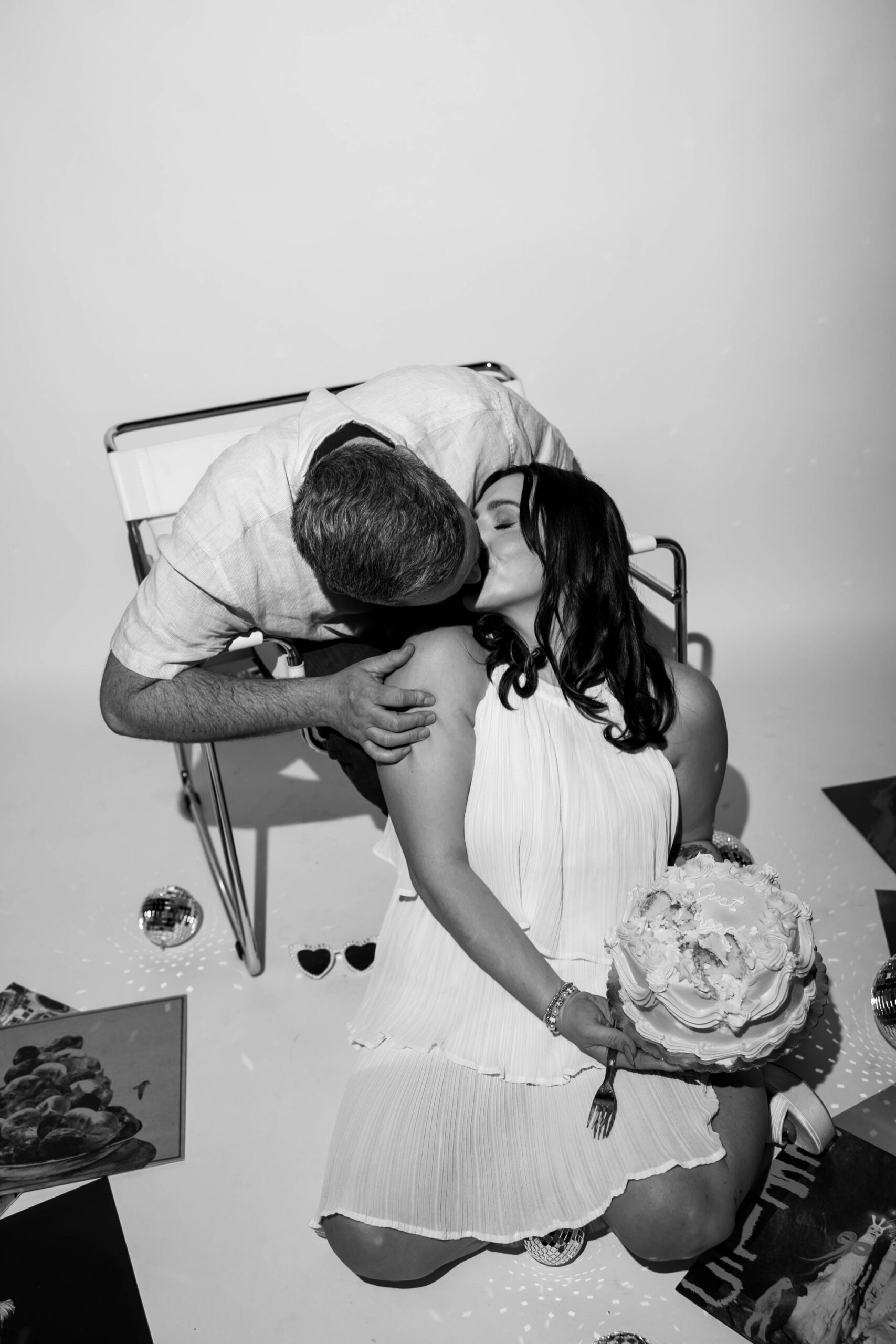 vinyl records, disco balls, and vintage-style cake for "just engaged" photo session