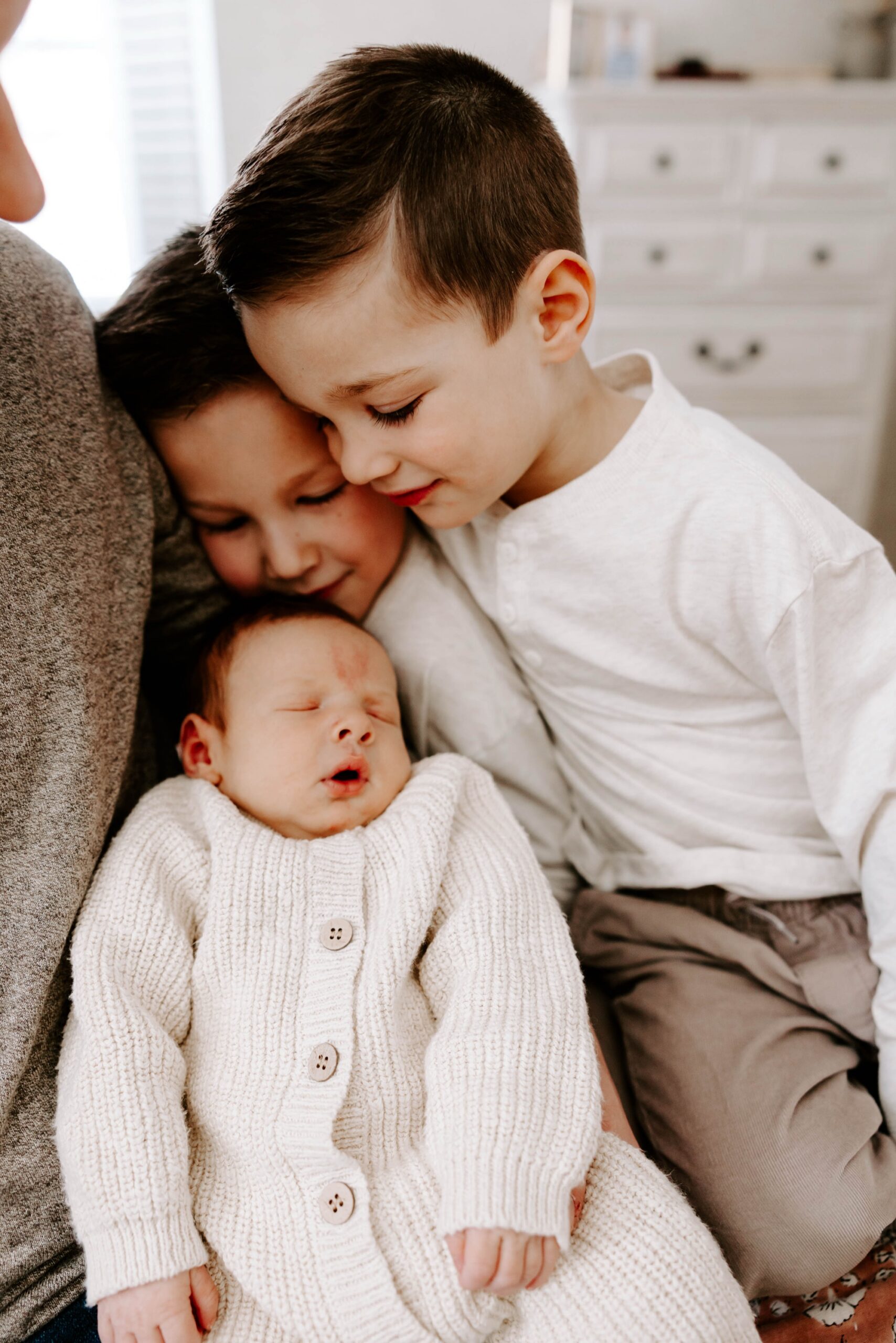 big brothers looking at baby brother