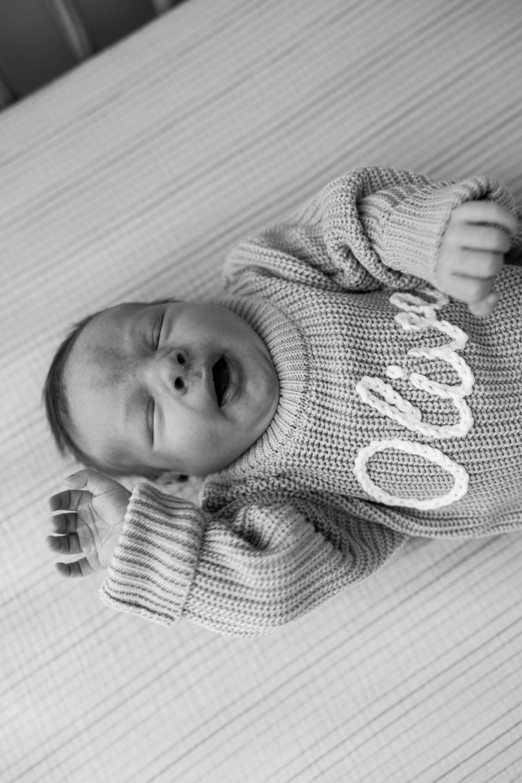 lifestyle newborn photography; personalized newborn knit name onesie sweater